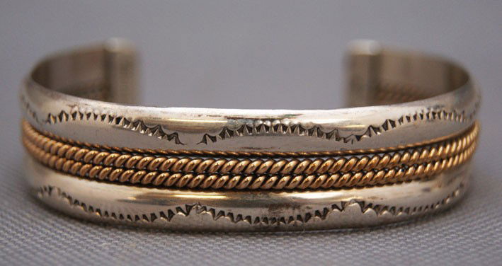Navajo bracelet: 1980s 90s sterling silver and 1/20 karat gold filled marked Taho, 5.25" x .5" x 1.25" Shipping charge are for the United States. The shipping on this lot is $10.00. Outside the United States there wil
