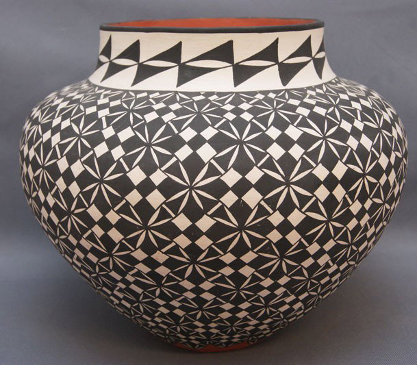 Acoma pottery jar: 1980s 90s black on white with pitting and rubs signed D. T., 9" x 10" Shipping charge are for the United States. The shipping on this lot is $10.00. Outside the United States there will be additional 