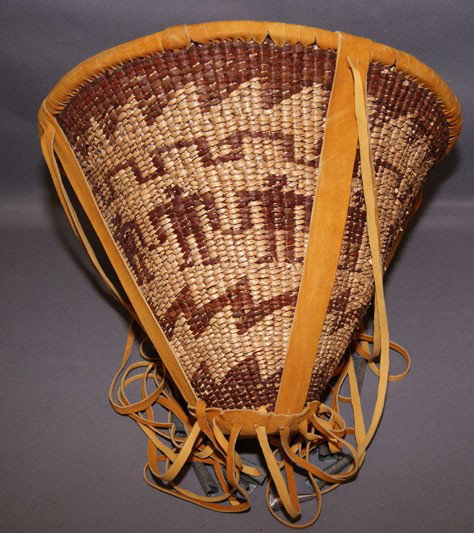 APACHE BURDEN BASKET: 1970s 80s with human figures woven, 12" x 14.5" not including fringe Shipping charge are for the United States. The shipping on this lot is $10.00. Outside the United States there will be additional s