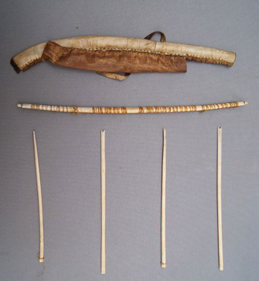 MINIATURE ESKIMO BOW CASE AND QUIVER: 1920s 30s both case and quiver made from hide with bone arrows, arrows missing heads, bow 10.5" x .5" Shipping charge are for the United States. The shipping on this lot is $10.00. Outside the United