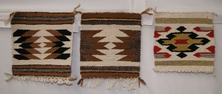 THREE MINIATURE NAVAJO TEXTILES: 1970s 80s handwoven geometric design, 11" x 10", and 10" x 10" The shipping on this lot is $10.00.