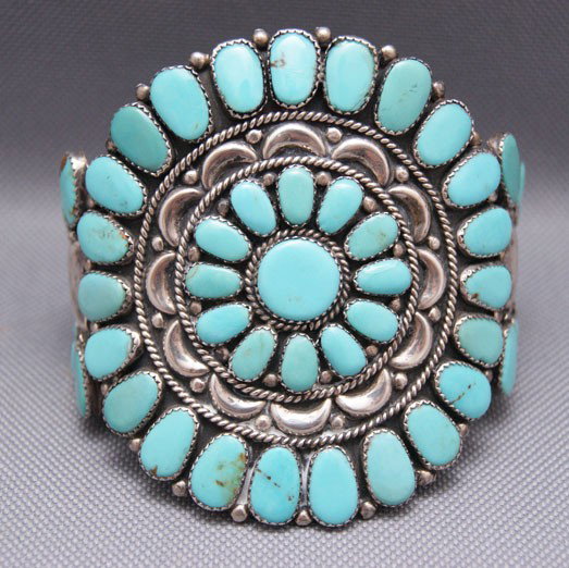 NAVAJO SILVER BRACELET: 1970s sterling silver and turquoise cluster type signed JW, 5.5" x 3" x 1.25" Shipping charge are for the United States. The shipping on this lot is $10.00. Outside the United States there will be add