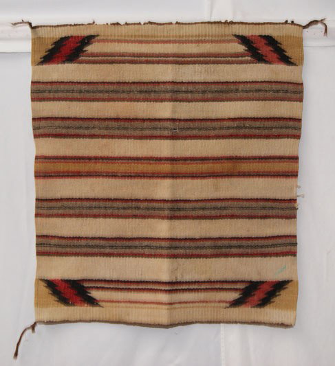 NAVAJO TEXTILE: 1970's banded design single saddle blanket has holes and stains, 30" x 26" Shipping charge are for the United States. The shipping on this lot is $10.00. Outside the United States there will be additi