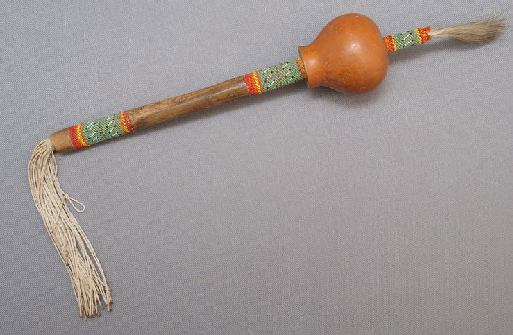 KIOWA PEYOTE RATTLE: 1950s gourd rattle with beaded handle, 13" long Shipping charge are for the United States. The shipping on this lot is $10.00. Outside the United States there will be additional shipping fees.