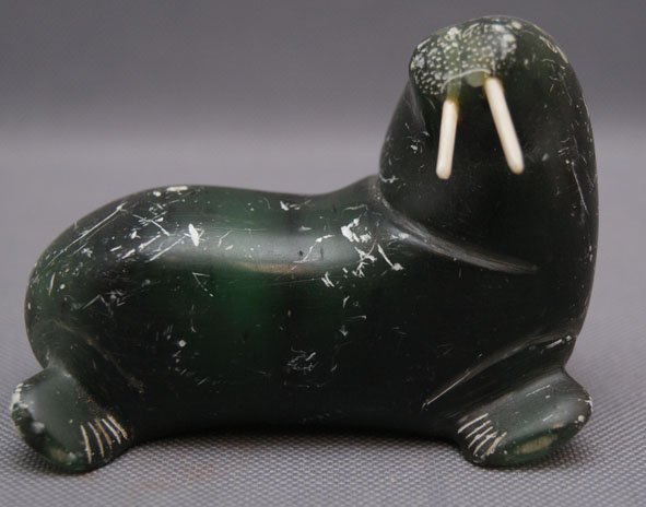 ESKIMO SEAL CARVING: 1940s carved soapstone walrus with ivory tusk, signed l Owen, 2.5" x 3.5" Shipping charge are for the United States. The shipping on this lot is $10.00. Outside the United States there will be additio