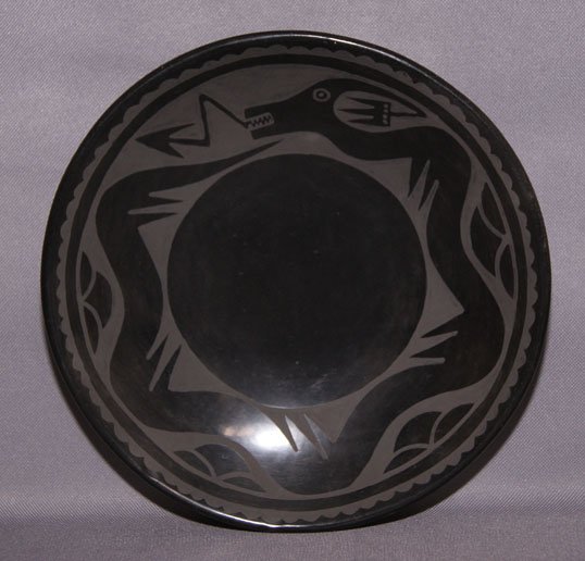 SAN ILDEFONSO POTTERY PLATE: 1970s Matte on black avanyu design, by Santana and Adam, 9" x 1.75" Shipping charge are for the United States. The shipping on this lot is $10.00. Outside the United States there will be additional sh