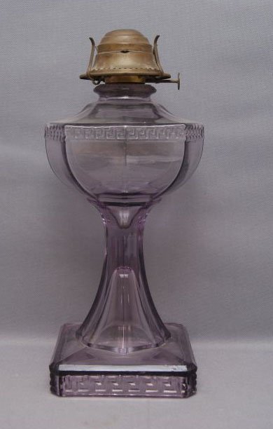 ANTIQUE LAMP: 1910 Sun turned purple glass, 12" tall Shipping charge are for the United States. The shipping on this lot is $15.00. Outside the United States there will be additional shipping fees.
