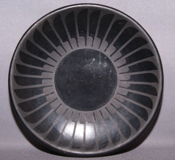 SAN ILDEFONSO POTTERY PLATE: 1950s, 60s matte on black feather design with minor scratches signed Maria Popovi, 6.5" diameter Shipping charge are for the United States. The shipping on this lot is $10.00. Outside the United State