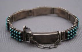 ZUNI BRACELET: 1970s 80s sterling silver and turquoise hinged style signed S. Holoo, 7" x .25" Shipping charge are for the United States. The shipping on this lot is $10.00. Outside the United States there will be a
