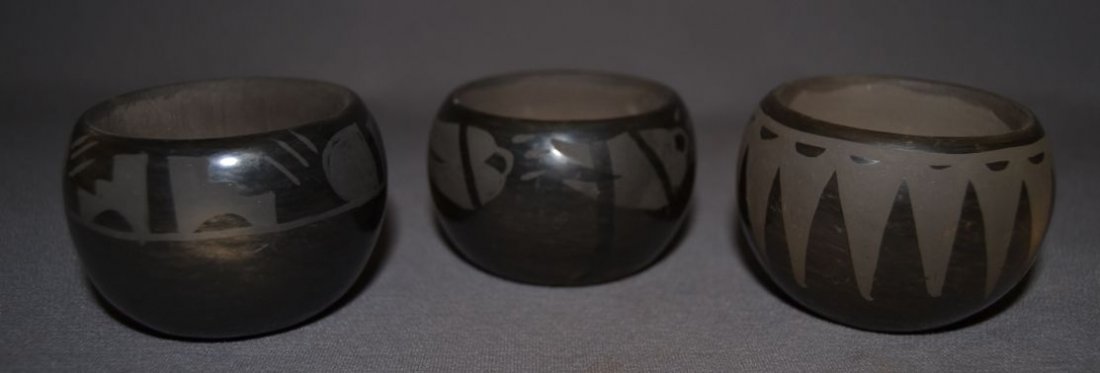 THREE SANTA CLARA POTS: 1980s 90s matte on black design 2 are signed Myra all have surface rubbing largest 2"x3" smallest has chip on rim and minor pitting signed Mary 1.75"x2.75" Shipping charge are for the United States. T