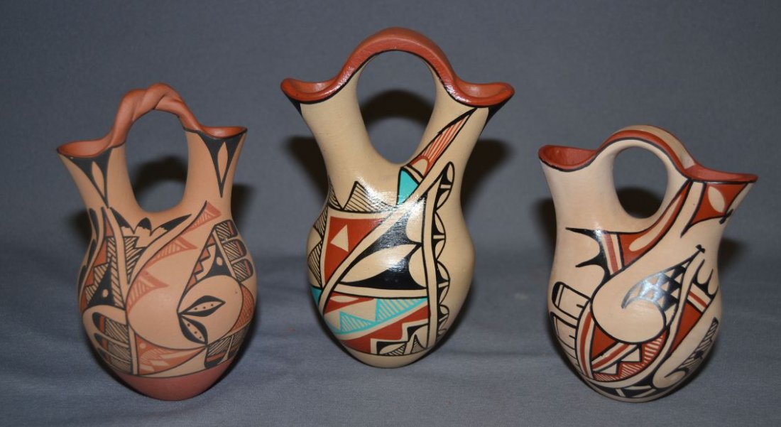 THREE JEMEZ POTTERY WEDDING VASES: 1980s 90s largest signed J.Baca 6.75"x4.5"x3" medium signed C. C. Tisa 6"x3.5"x3" smallest signed Savaging 5"x4"x3" all are polychrome Shipping charge are for the United States. The shipping on this l