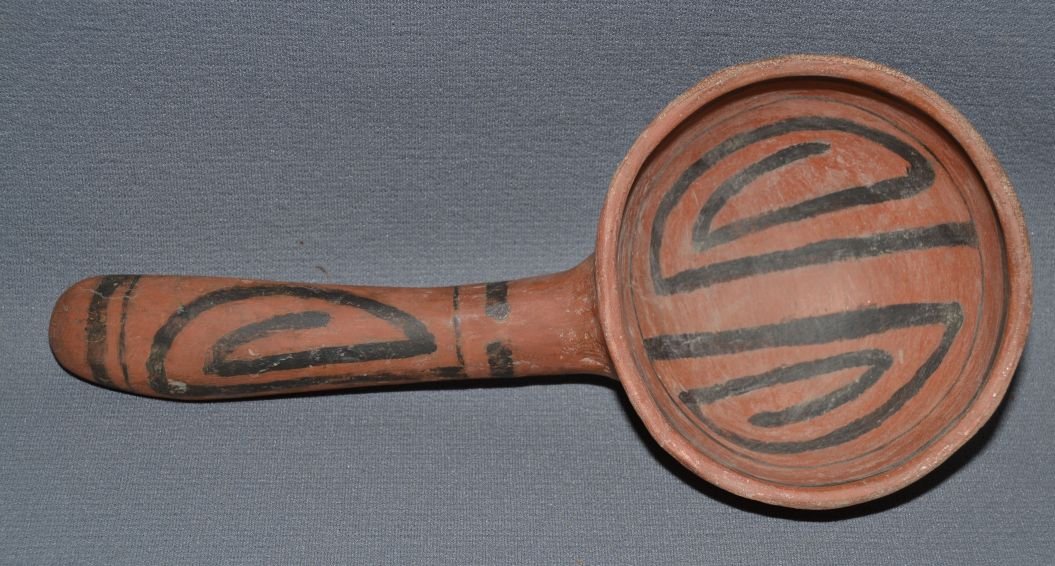 SAINT JOHNS POTTERY LADLE: prehistoric handle is plaster black on red geometric design 10.5"x4.5"x2.5" Shipping charge are for the United States. The shipping on this lot is $20.00. Outside the United States there will be addit