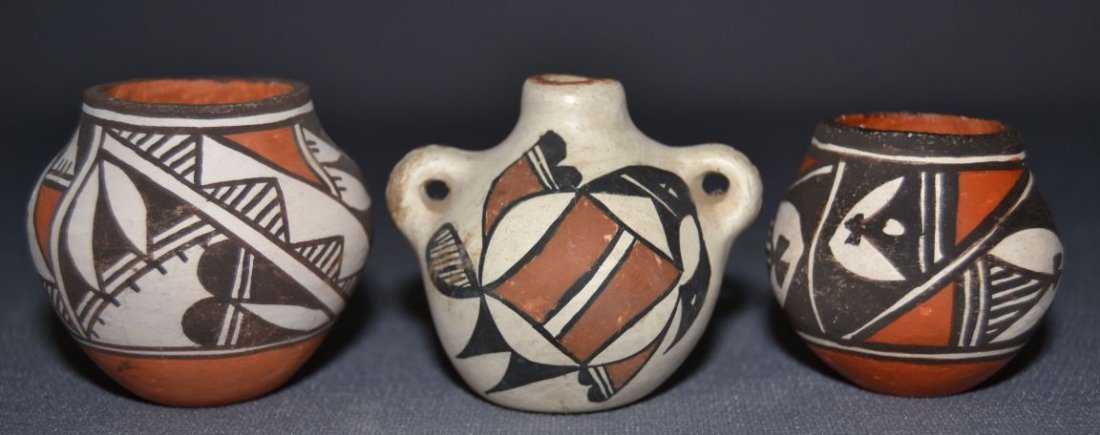 THREE ACOMA POTS: 1980s 90s largest polychrome design signed R. Leno 2"x2.25" canteen polychrome 2"x2.5"x2" smallest polychrome signed Joyce L. all have surface rubs 1.75"x2" Shipping charge are for the United States. 