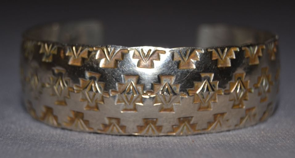 NAVAJO SILVER BRACELET: 1980s 90s sterling silver stamped design signed with logo 5.75"x.75"x1" Shipping charge are for the United States. The shipping on this lot is $10.00. Outside the United States there will be additiona