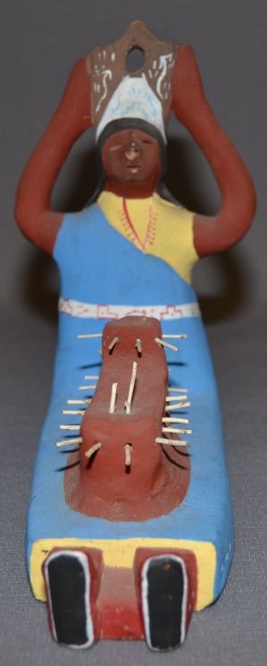 TESUQUE POTTERY FIGURE: 1980s 90s seated figure with painted design Kiva has broken poles 6.5"x7"x2.75" Shipping charge are for the continental United States only There will be additional shipping fees on shipments to Hawaii