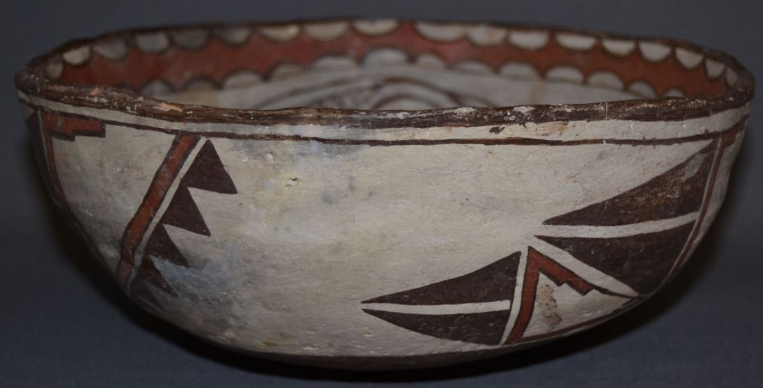 ZUNI POTTERY BOWL: 1910s 20s polychrome geometric design has restoration and crack 5% plaster 4.75"x11.5" Shipping charge are for the continental United States only There will be additional shipping fees on shipments to