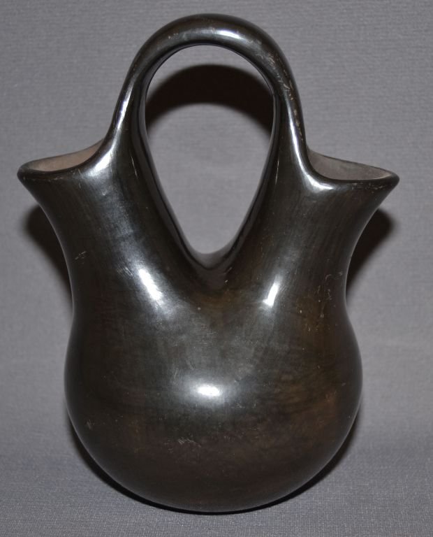 SAN ILDEFONSO POTTERY WEDDING VASE: 1970s 80s black ware has surface scratches signed Blue Corn 7"x6"x1.5" Shipping charge are for the continental United States only There will be additional shipping fees on shipments to Hawaii, Alaska