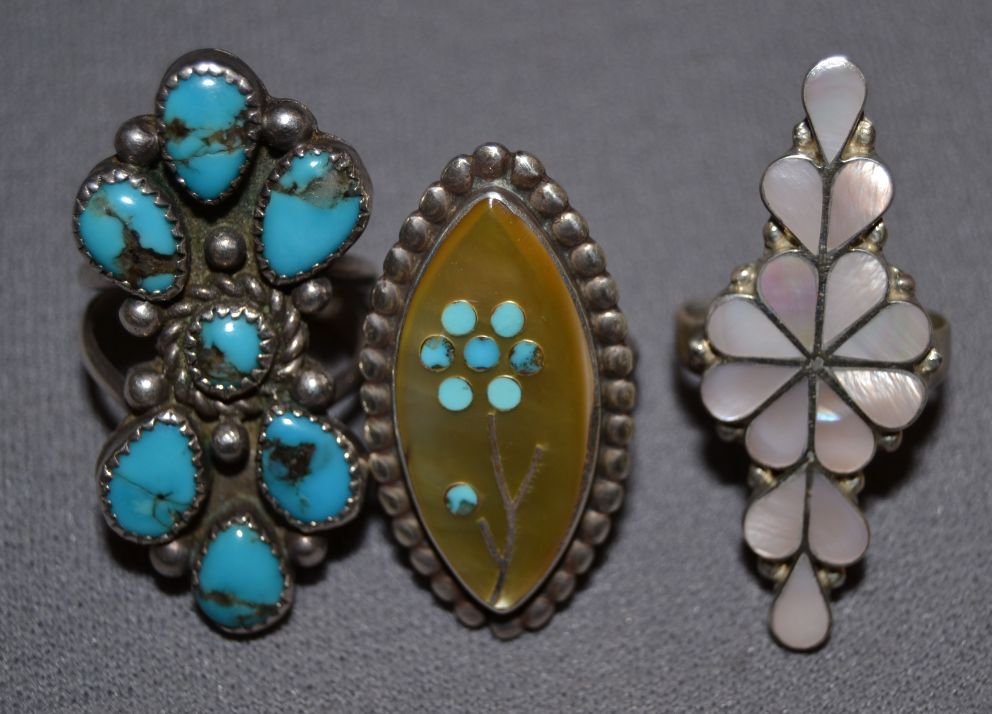 THREE NAVAJO RINGS: 1970s 80s sterling silver largest has 7 turquoise stones size 8 channel inlay mother of pearl ring size 6 stone to stone floral design size 6.5 Shipping charge are for the continental United States on