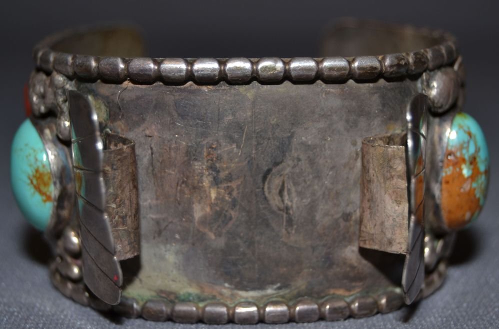 NAVAJO MEN'S WATCHBAND: 1960s 70s sterling silver 4 turquoise and 2 coral stones 5.75"x1.5"x1.25" Shipping charge are for the continental United States only There will be additional shipping fees on shipments to Hawaii, Alas
