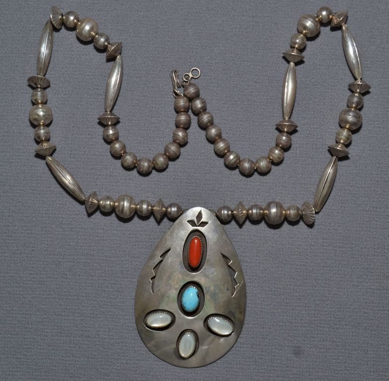 NAVAJO SILVER NECKLACE: 1970s 80s sterling silver pendant has coral turquoise and mother of pearl stones 24" long Shipping charge are for the continental United States only There will be additional shipping fees on shipments