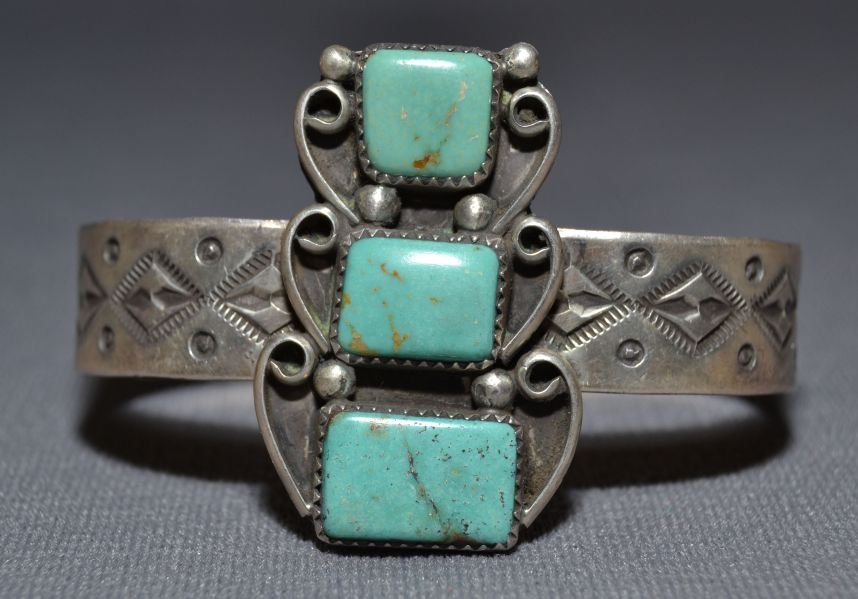 NAVAJO SILVER BRACELET: 1980s 90s sterling silver stamped design 3 square turquoise stones signed HH 5.5"x1.75"x1" Shipping charge are for the continental United States only There will be additional shipping fees on shipment