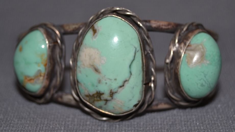 NAVAJO SILVER BRACELET: 1960s 70s sterling silver 3 turquoise stones 5"x1.25"x1.5" Shipping charge are for the continental United States only There will be additional shipping fees on shipments to Hawaii, Alaska and outside 