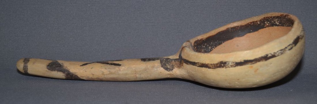 JEDDITO POTTERY LADLE: prehistoric brown on yellow geometric design handle is plaster 10.5"x4.75"x2.25" Shipping charge are for the continental United States only There will be additional shipping fees on shipments to Hawai