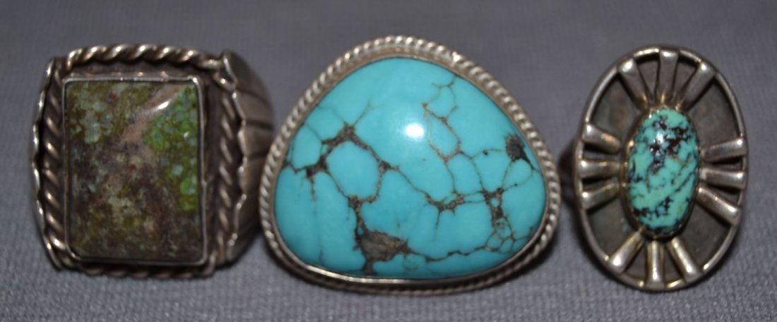 THREE NAVAJO SILVER RINGS: 1960s 70s sterling silver mans style all have turquoise stones largest size 10.5 smallest signed PM size 7.5 Shipping charge are for the continental United States only There will be additional shippin