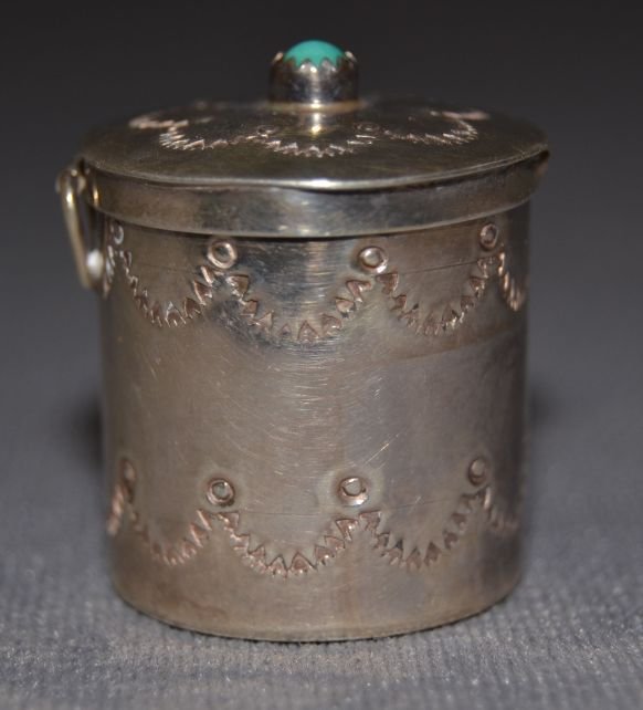 NAVAJO SILVER CONTAINER: 1970s sterling silver stamped design single turquoise stone signed E. M. W. 1.25"x1" Shipping charge are for the continental United States only There will be additional shipping fees on shipments to H