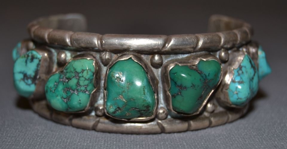 NAVAJO SILVER BRACELET: 1960s 70s sterling silver 7 turquoise stones 5.75"x1.25"x1.75" Shipping charge are for the continental United States only There will be additional shipping fees on shipments to Hawaii, Alaska and outs
