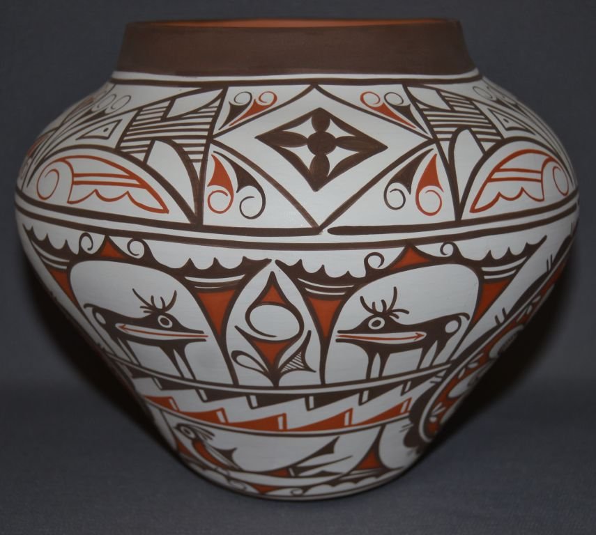 ZUNI CERAMIC JAR: 2004 polychrome geometric and heart line deer design signed C. haloo 7.25"x9" Shipping charge are for the continental United States only There will be additional shipping fees on shipments to Hawaii, 