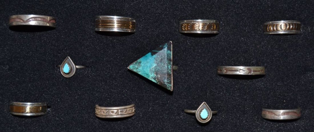 ELEVEN SILVER NAVAJO RINGS: 1980s 90s sterling silver some have gold largest shadow box arrow design size 12 Shipping charge are for the continental United States only There will be additional shipping fees on shipments to Hawai