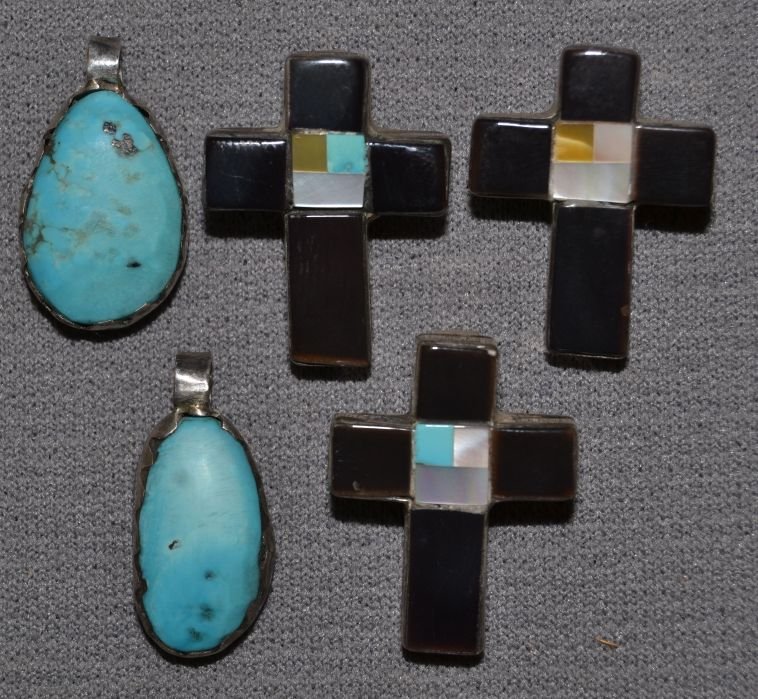 FIVE NAVAJO PENDANTS: 1970s 80s sterling silver three stone to stone crosses 1"x.75" 2 with single turquoise stones 1"x.5" Shipping charge are for the continental United States only There will be additional shipping fees o