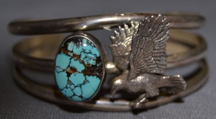 NAVAJO SILVER BRACELET: 1970s 80s sterling silver 3D eagle design with single turquoise stone 5.75"x1.25"x1" Shipping charge are for the continental United States only There will be additional shipping fees on shipments to H