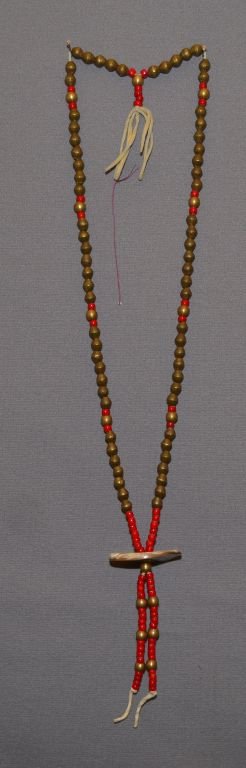 PLAINS INDIAN NECKLACE: 1940s 50s brass and glass beads with shell gorget 26" long Shipping charge are for the continental United States only There will be additional shipping fees on shipments to Hawaii, Alaska and outside