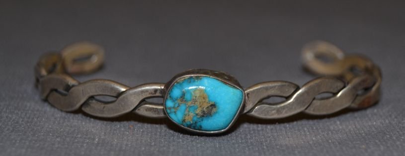 NAVAJO SILVER BRACELET: 1960s 70s sterling silver twisted wire design single turquoise stone 5.25"x.25"x.75" Shipping charge are for the continental United States only There will be additional shipping fees on shipments to H