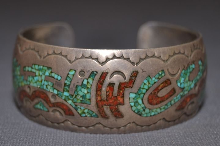 NAVAJO SILVER BRACELET: 1960s 70s sterling silver stamped design and chip inlay turquoise and coral 5.75"x1"x1" Shipping charge are for the continental United States only There will be additional shipping fees on shipments t