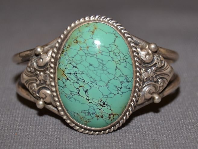 NAVAJO SILVER BRACELET: 1980s 90s sterling silver single turquoise stone design is from silverware 4.5"x1.5"x1.25" Shipping charge are for the continental United States only There will be additional shipping fees on shipment