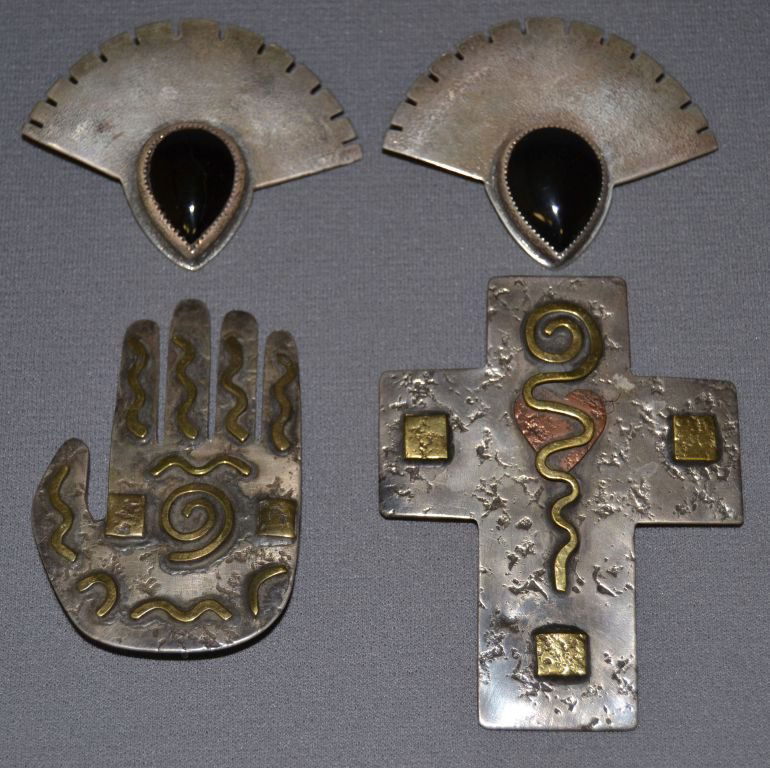 FOUR APACHE PENDANTS: contemporary silver cross 3.5" x 2.75", stylized gan dance mask 2"x 2.5"and hand design 3" x 2" all are signed Loco, Shipping charge are for the continental United States only There will be additional