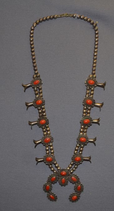 NAVAJO SQUASH NECKLACE: 1970's sterling silver and coral 27" long with 3" x 3" naja Shipping charge are for the continental United States only There will be additional shipping fees on shipments to Hawaii, Alaska and outside