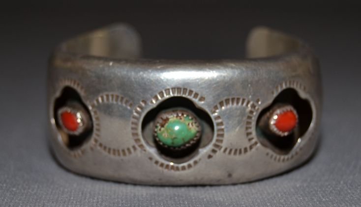 NAVAJO SILVER BRACELET: 1960s 70s sterling silver stamped design shadow box style 2 coral stones 1 turquoise stone 5.25"x1.25"x1" Shipping charge are for the continental United States only There will be additional shipping f