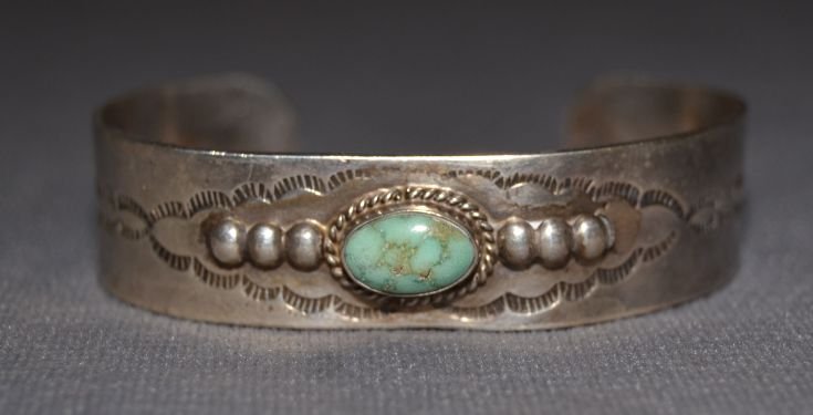 NAVAJO SILVER BRACELET: 1960s 70s sterling silver stamped design single turquoise stone 5.25"x.5"x1" Shipping charge are for the continental United States only There will be additional shipping fees on shipments to Hawaii, A