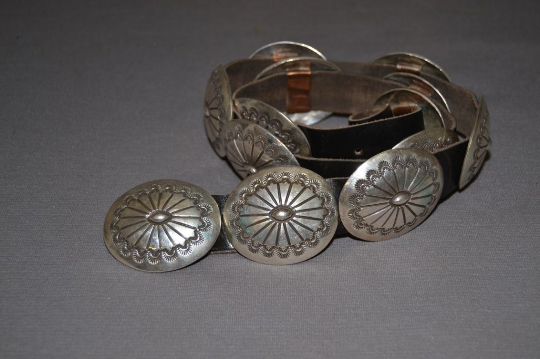 NAVAJO SILVER CONCHO BELT: 1980s 90s sterling silver stamped design buckle 1.75"x2.25" 12 conchos 1.75"x2" 34" long Shipping charge are for the continental United States only There will be additional shipping fees on shipments 