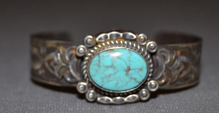 NAVAJO SILVER BRACELET: 1980s 90s sterling silver stamped design single turquoise stone signed with S 5.25"x 1"x 1" Shipping charge are for the continental United States only There will be additional shipping fees on shipmen