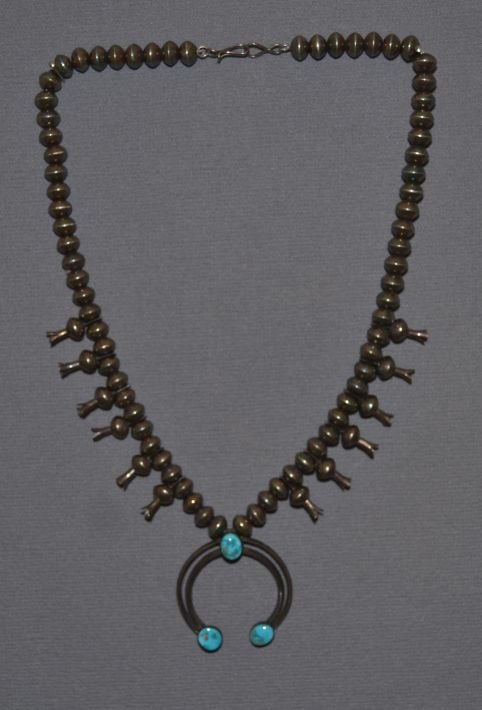 NAVAJO SQUASH BLOSSOM NECKLACE: 1970's sterling silver beads 22'' long with sterling and turquoise Naja 2'' x 2'' Shipping charge are for the continental United States only There will be additional shipping fees on shipments to Hawa