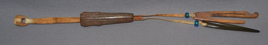 ESKIMO NEEDLE CASE: 1910-20s fossilized ivory, with tools, total length 14" long Shipping charge are for the continental United States only There will be additional shipping fees on shipments to Hawaii, Alaska and outsid