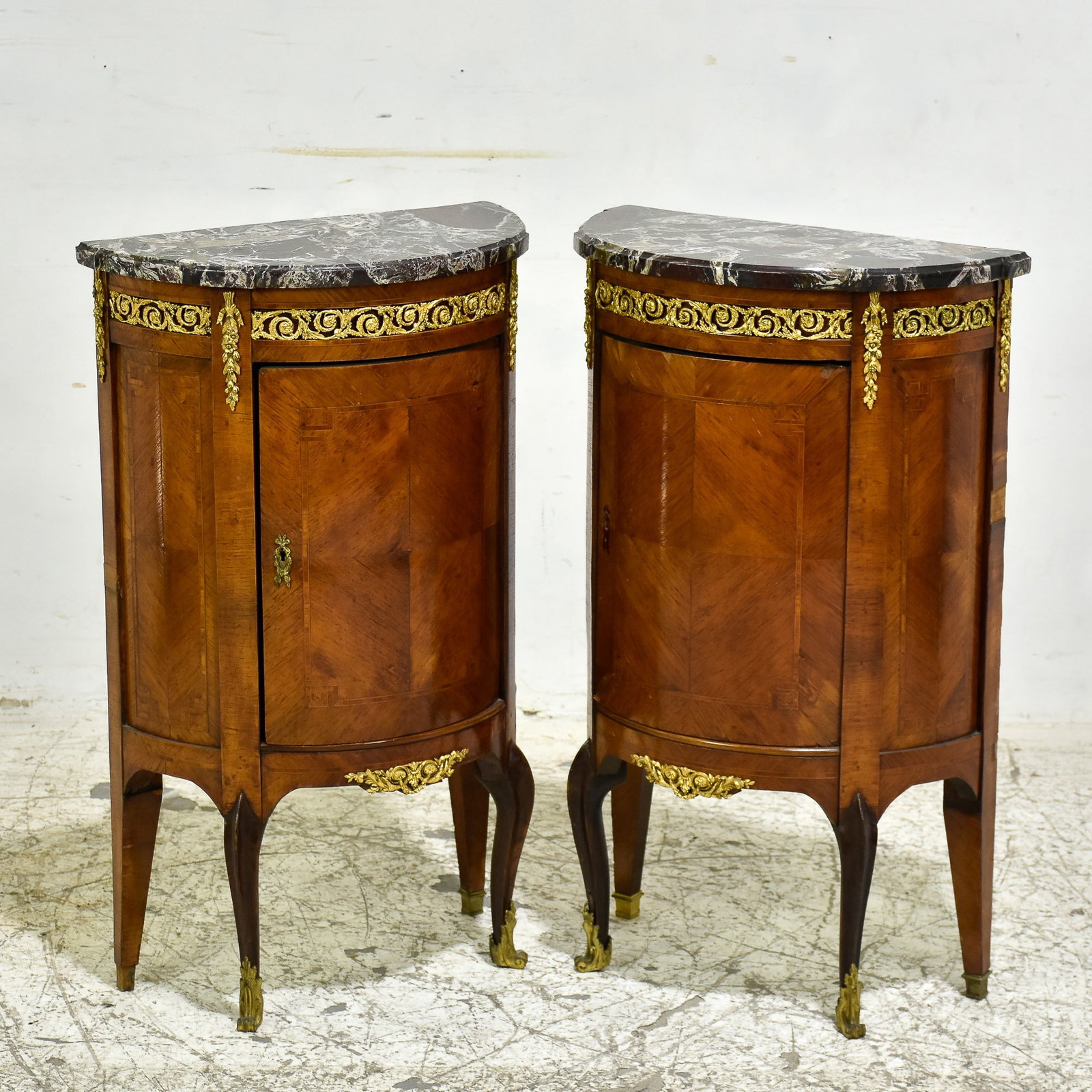 Pair of Louis XV/XVI-Style Gilt-Metal Mounted Parquetry Cabinets: * (33” h x 19 7/8” w x 10 1/4” ) One brass cap off foot, some lifting to veneers