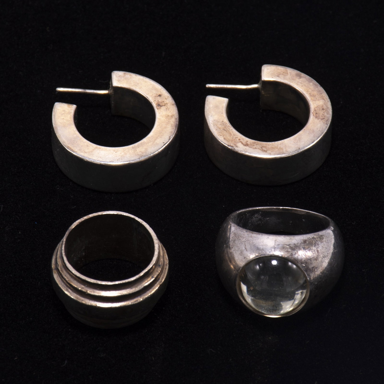 Group of Sterling Silver Jewelry: Comprising a pair of hoop earrings, Lalique glass inserted ring, and a silver band ring Ap. 1.4 ounces * (Earrings 1" dia ; Ring Sizes 7 1/2, 5 1/2 ) Scratches, tarnishing