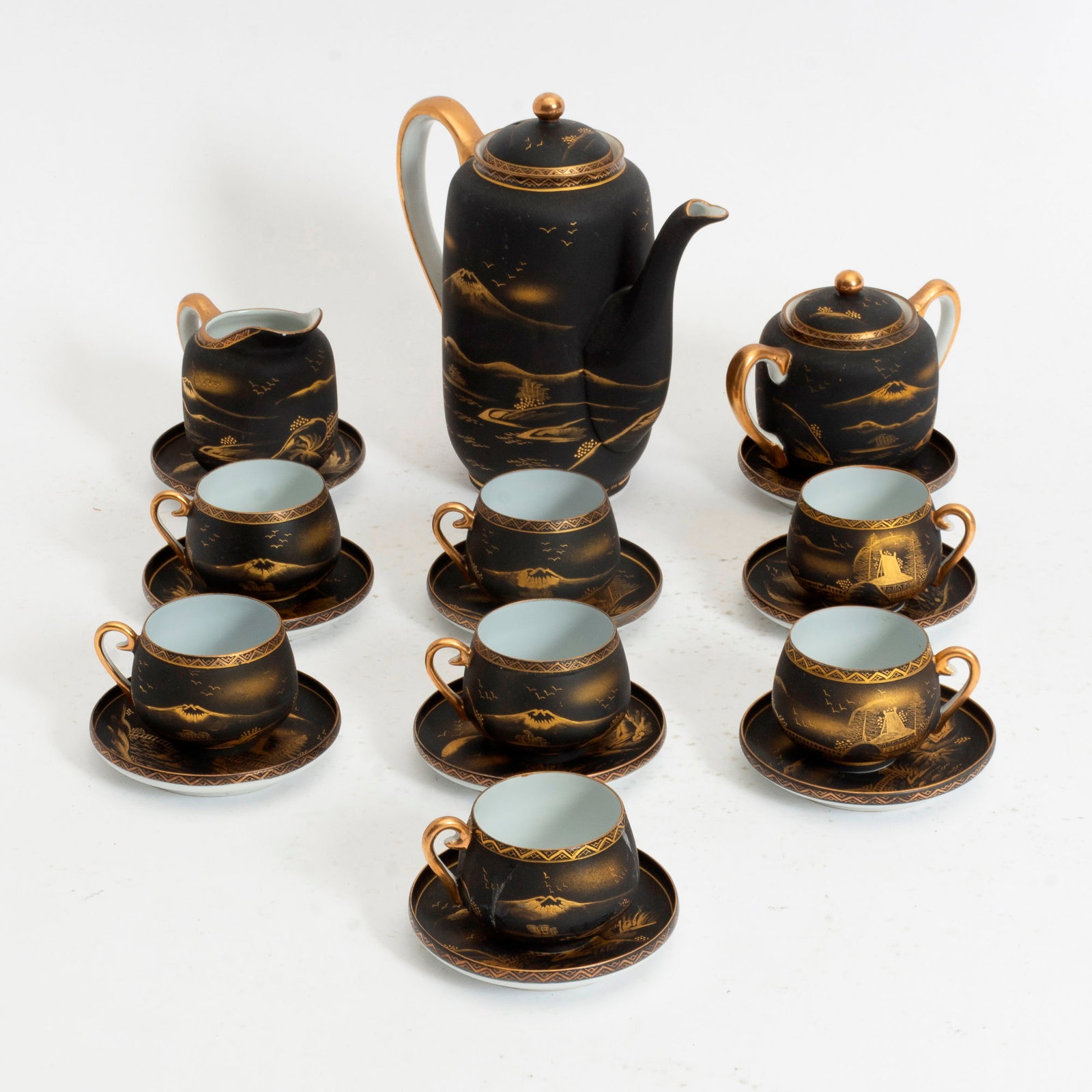 Japanese Porcelain Tea Service: Comprising 7 cups, 9 saucers, creamer, sugar bowl, teapot * (Teapot 7" h) hairline crack to one