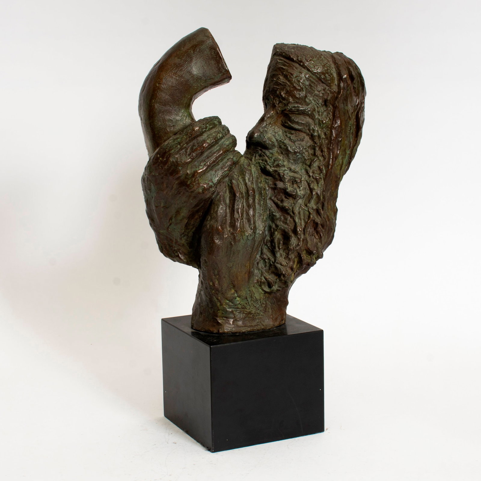 20th Century School: Man Blowing a Shofar, 1962 Bronze with green-brown patina on hardstone base Monogramed indistinctly and dated '62 * (14 1/4" h Overall 20" h) Good